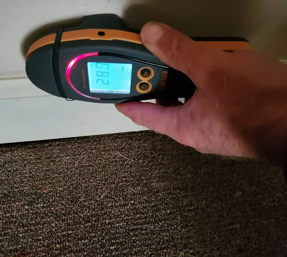 Moisture detection at baseboard during Storm Damage Restoration in Glenn Dale